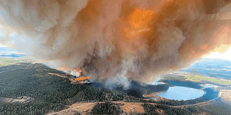 A smoke column rises from wildfire near Lodgepole Alberta Canada on May 4 2023 amd