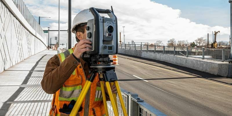 Surveyor monitoring infrastructure project using S9 total station and Trimble Access Monitoring field software 1
