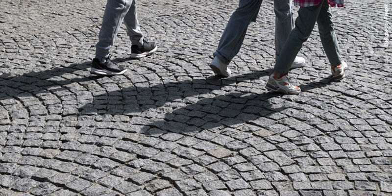 Outdoors cobblestone texture with pedestrians THUMBNAIL